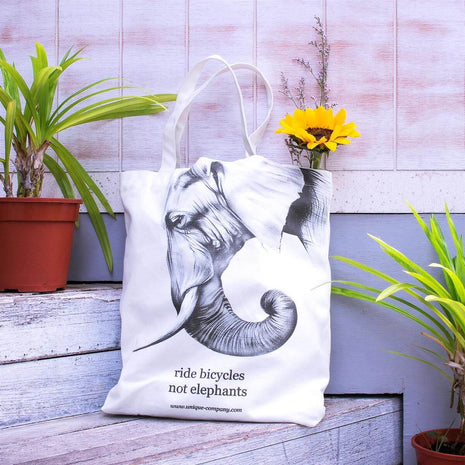 "ride bicycles not elephants" tote bag